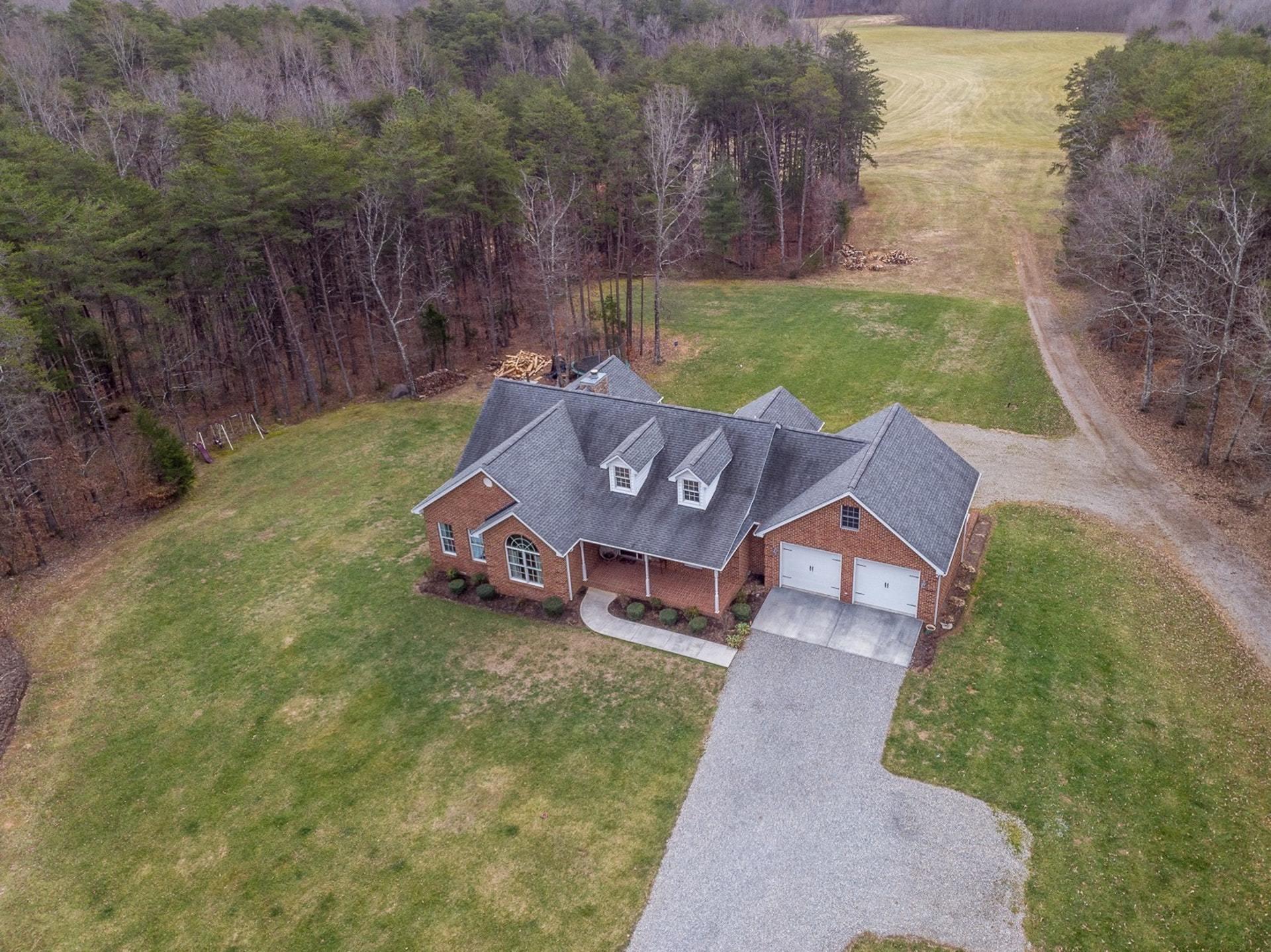 565 Charlie Road Hardy, VA 24101 - Photo 49 of 58 an aerial view of a house with garden space and a bench