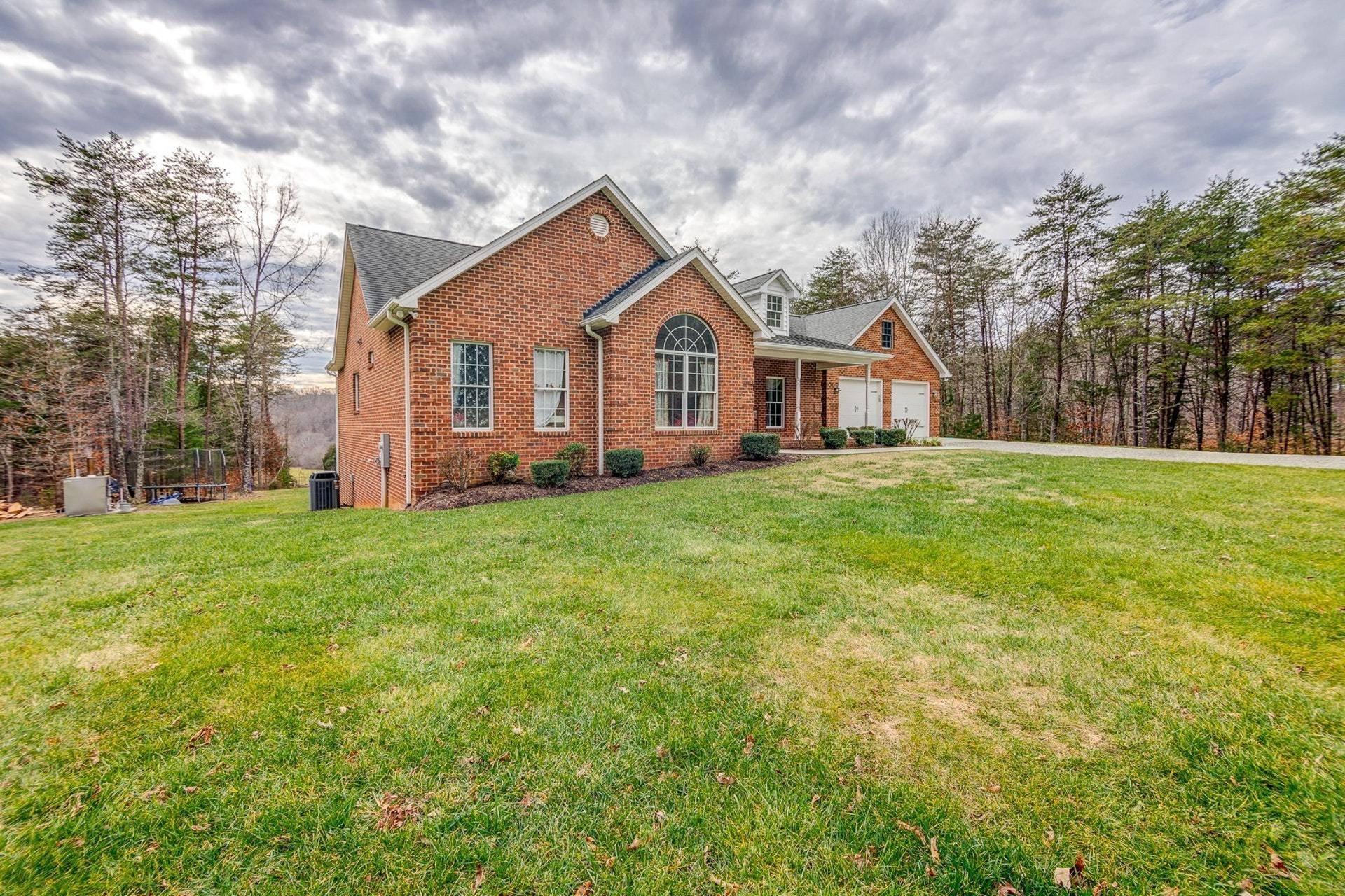 565 Charlie Road Hardy, VA 24101 - Photo 50 of 58 a front view of a house with a yard and trees