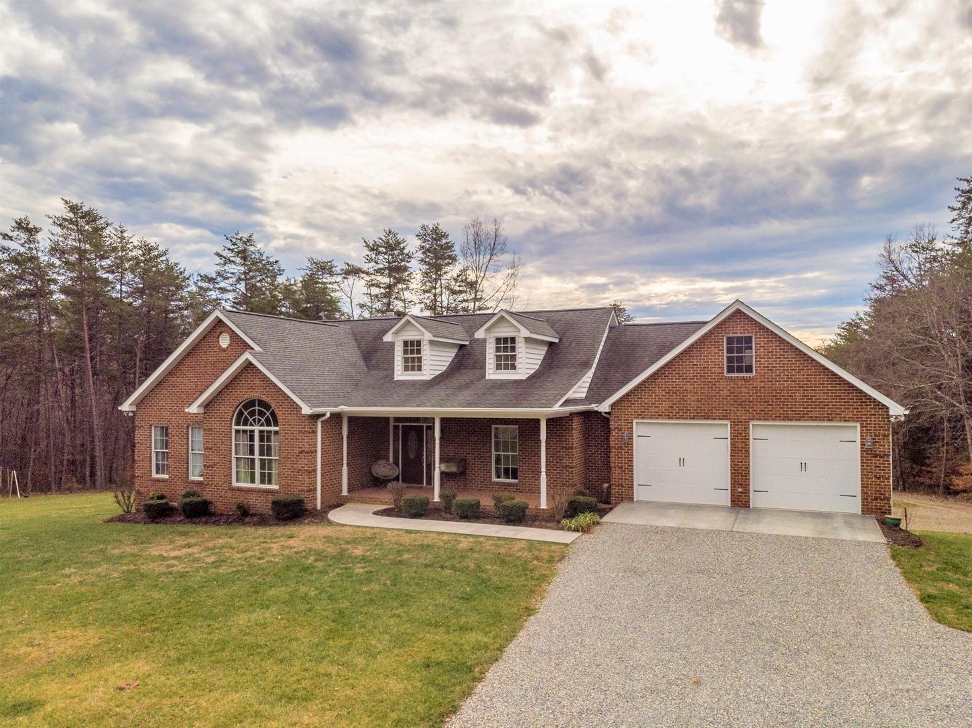 565 Charlie Road Hardy, VA 24101 - Photo 51 of 58 a front view of a house with a yard and garage