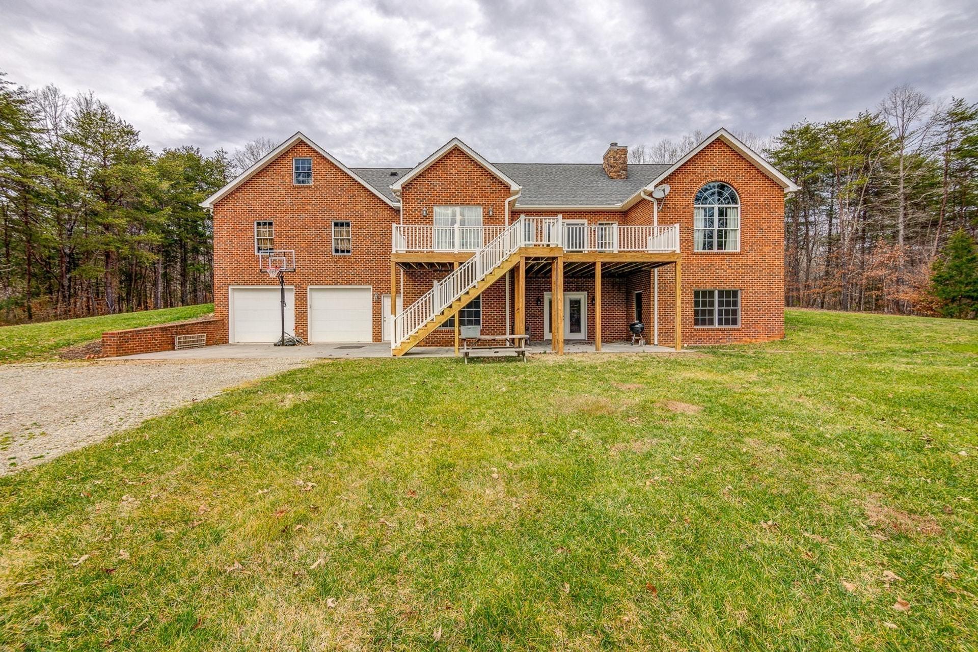 565 Charlie Road Hardy, VA 24101 - Photo 53 of 58 a front view of a house with a yard and garage