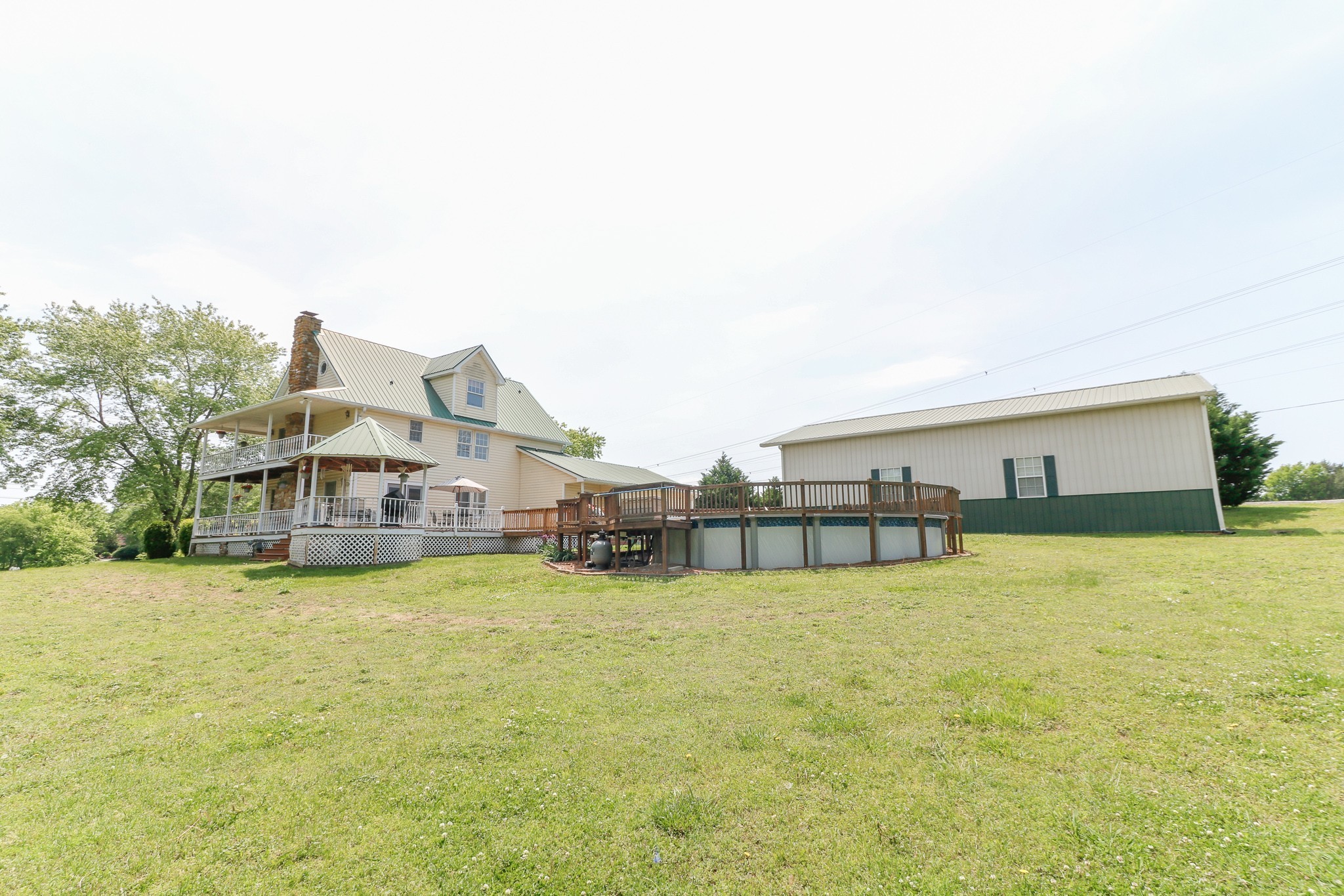 9801 Central Pike Mount Juliet, TN 37122 - Photo 34 of 42 a view of a swimming pool with lawn chairs and large trees