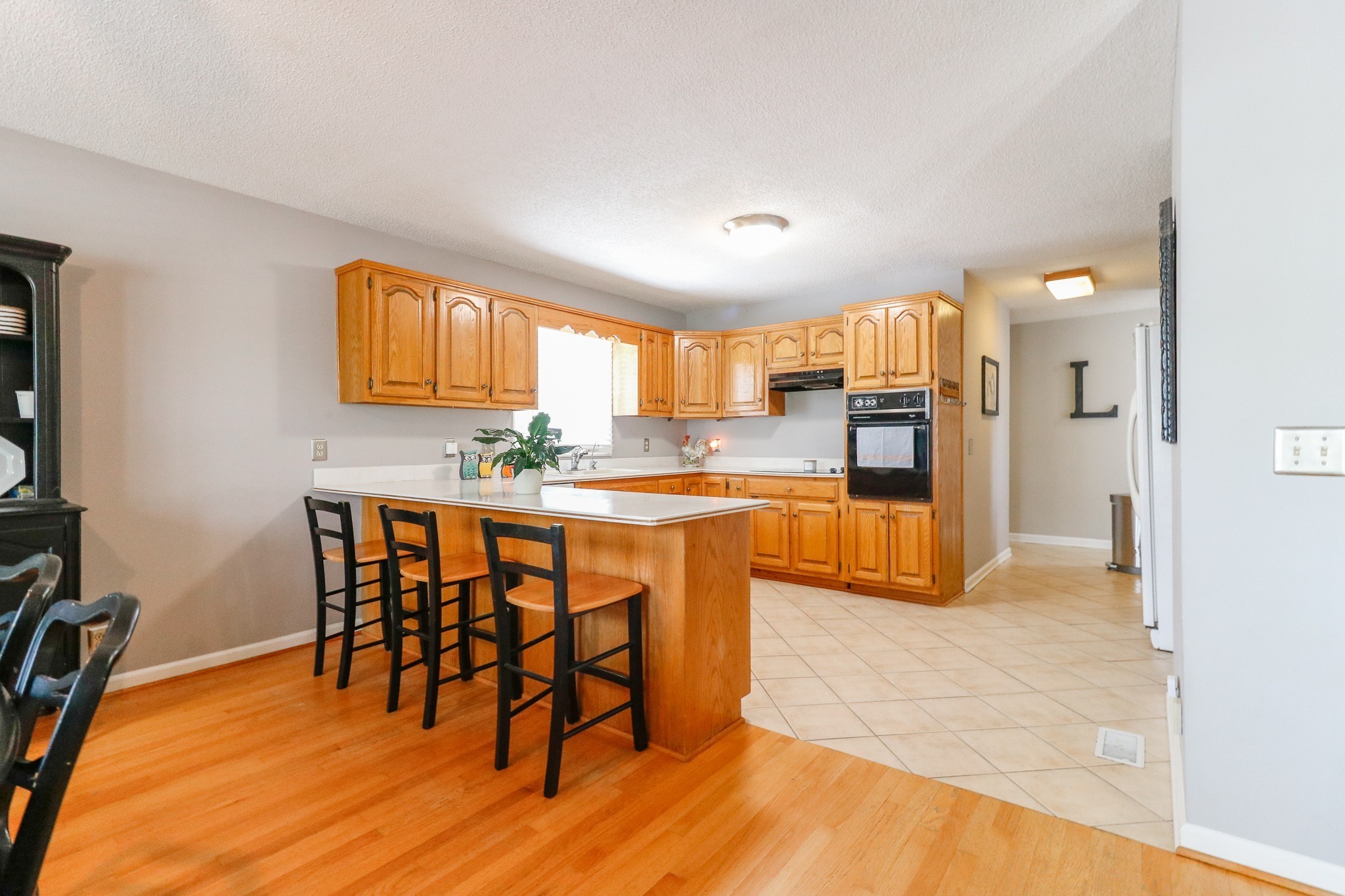 9801 Central Pike Mount Juliet, TN 37122 - Photo 10 of 42 a kitchen with kitchen island granite countertop wooden floors and a view of living room