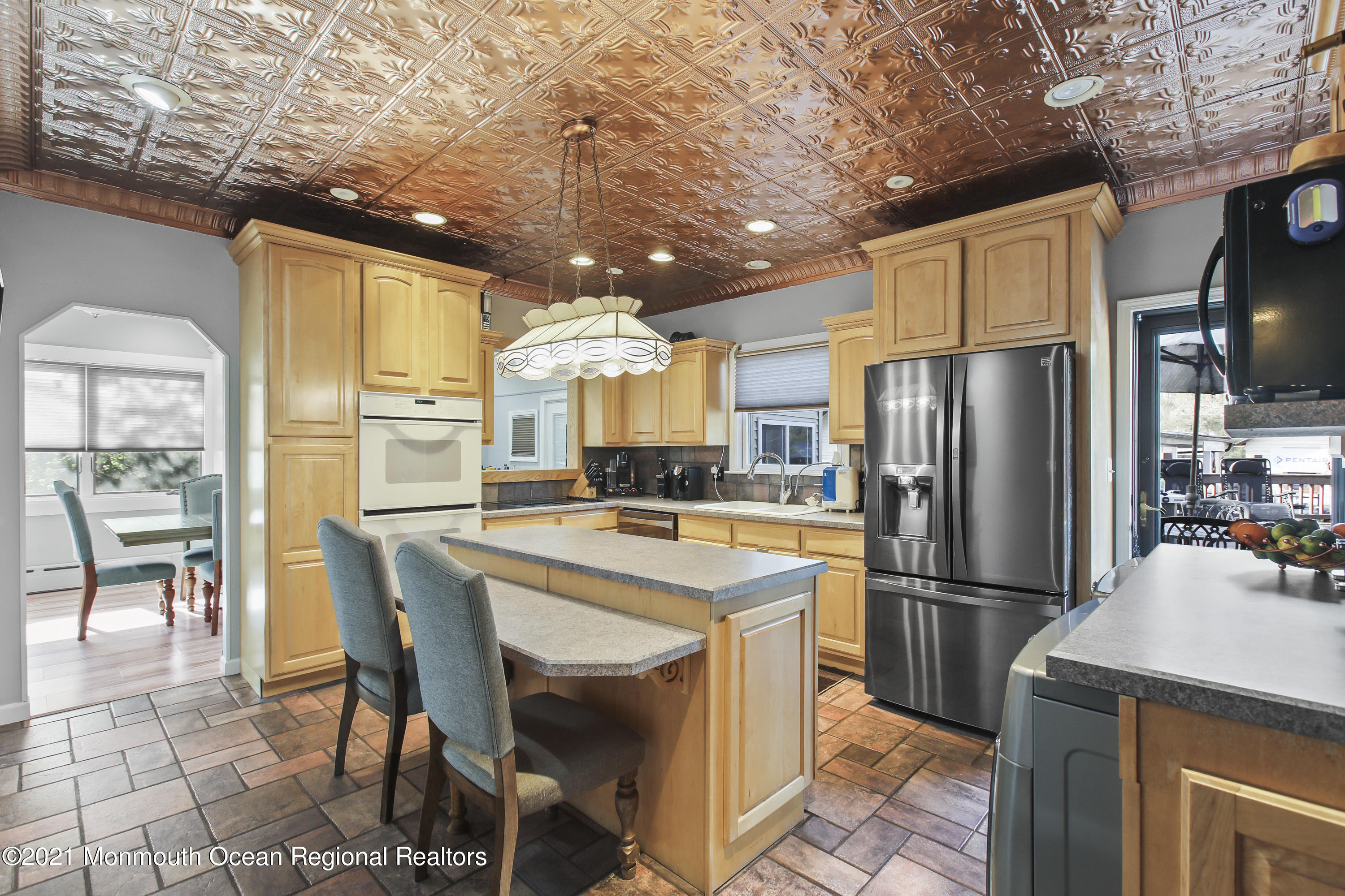 450 North County Line Road Jackson, NJ 08527 - Photo 13 of 35 a kitchen with stainless steel appliances a refrigerator a stove a sink a dining table and chairs