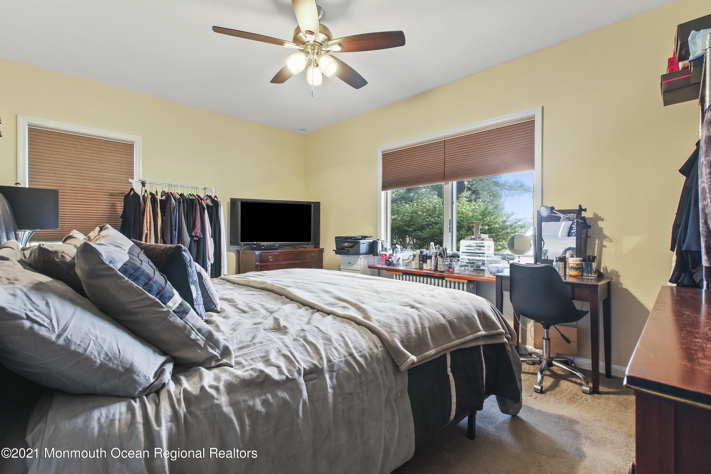 450 North County Line Road Jackson, NJ 08527 - Photo 18 of 35 a bedroom with a bed and a chandelier