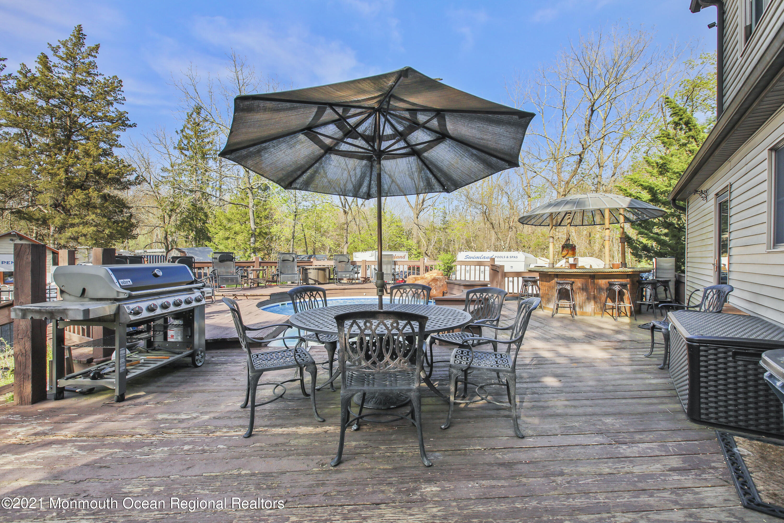 450 North County Line Road Jackson, NJ 08527 - Photo 29 of 35 a view of a patio with a table and chairs under an umbrella