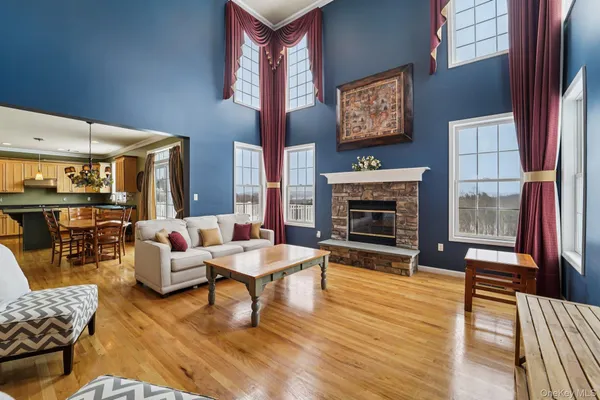 a kitchen with stainless steel appliances granite countertop a refrigerator a stove and a wooden floors