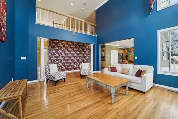 a dining room with furniture a chandelier and wooden floor