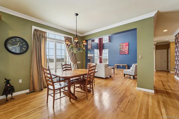 a view of entryway and dining room and wooden floor