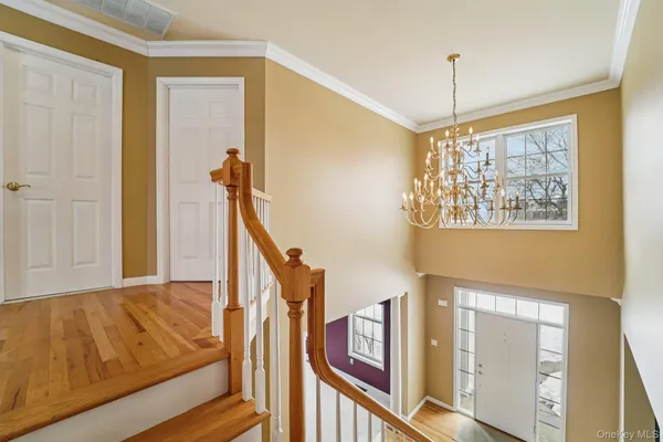 a spacious bedroom with a bed and wooden floor