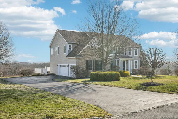 a view of a hallway with wooden floor and windows