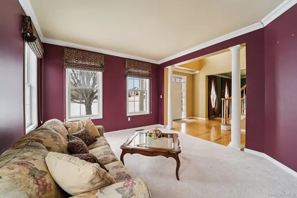 a view of an empty room with a window and a kitchen