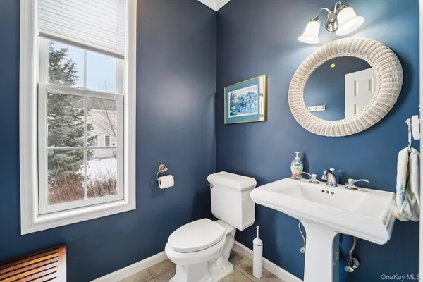 a living room with furniture a fireplace and a large window