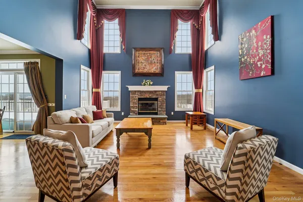 a kitchen with stainless steel appliances granite countertop a refrigerator a sink dishwasher a stove and white countertops with wooden floor