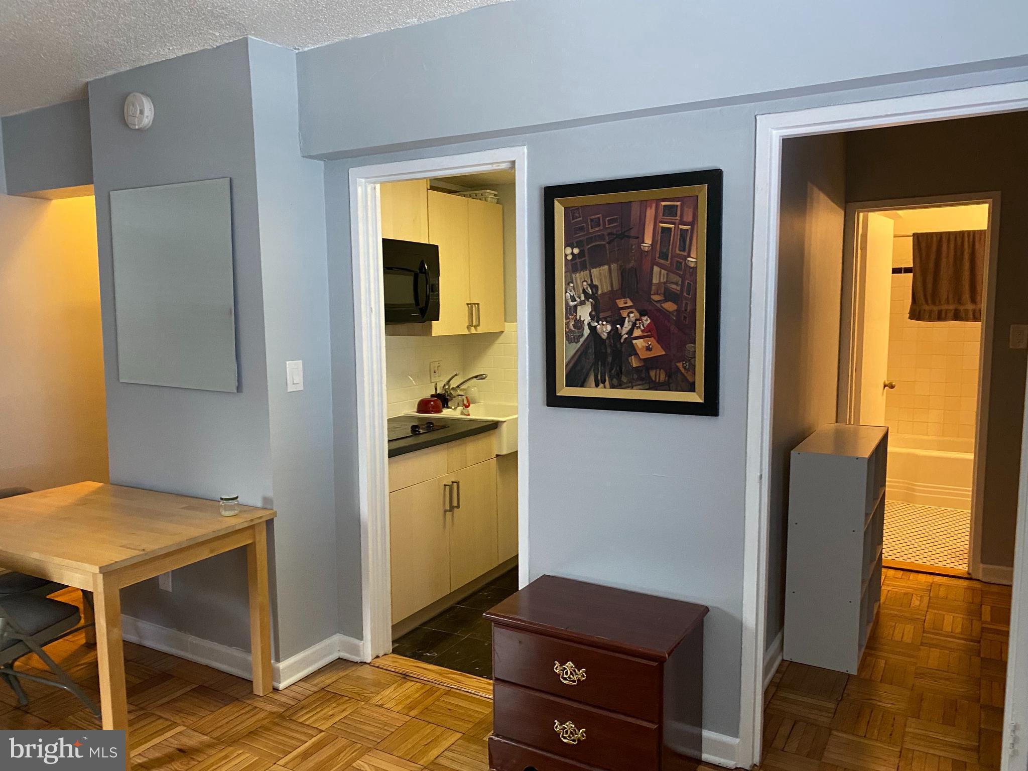 2141 I Street Northwest, Unit 607 Washington, DC 20037 - Photo 4 of 18 a view of kitchen with furniture and wooden floor