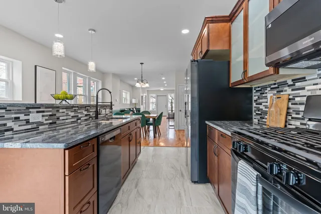 a kitchen with stainless steel appliances granite countertop a stove and a sink