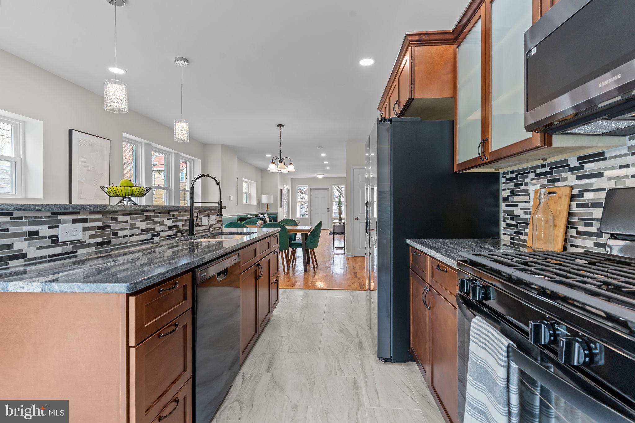 2142 North 58th Street Philadelphia, PA 19131 - Photo 12 of 36 a kitchen with stainless steel appliances granite countertop a stove and a sink
