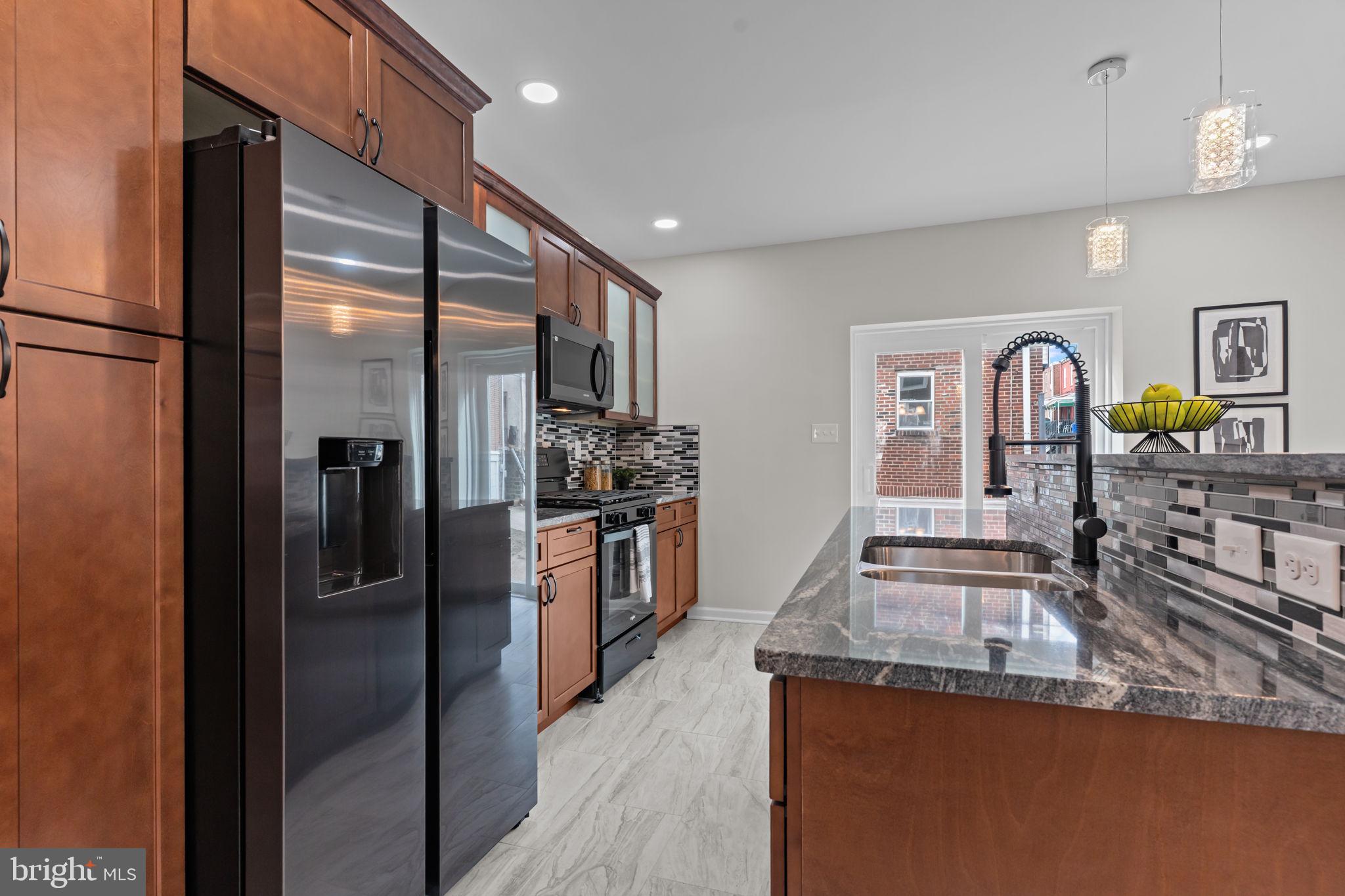2142 North 58th Street Philadelphia, PA 19131 - Photo 14 of 36 a kitchen with stainless steel appliances granite countertop a refrigerator and a stove