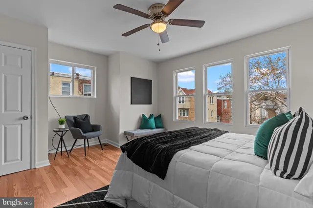a bedroom with a bed lamps and chairs