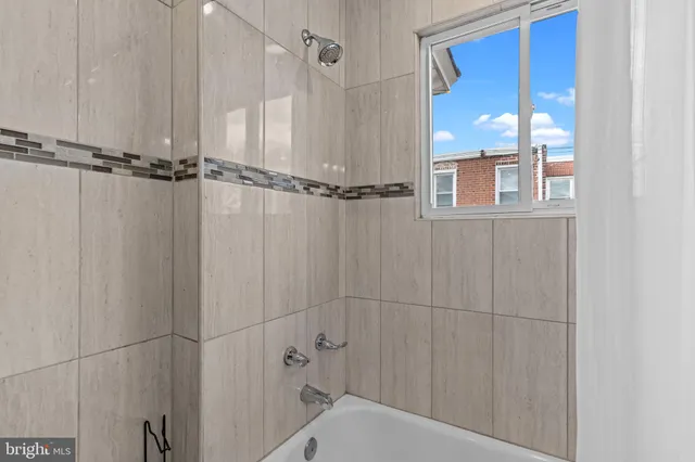 a bathroom with a shower and a window