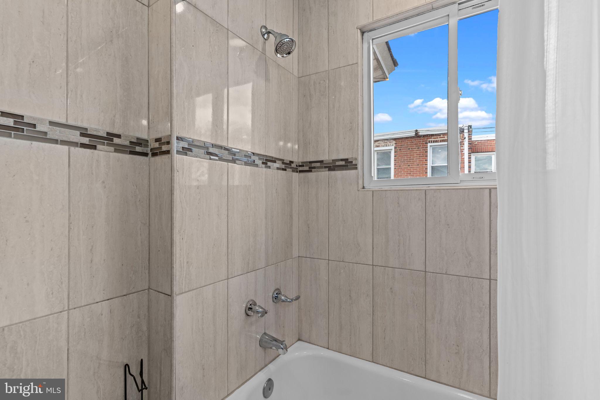 2142 North 58th Street Philadelphia, PA 19131 - Photo 19 of 36 a bathroom with a shower and a window