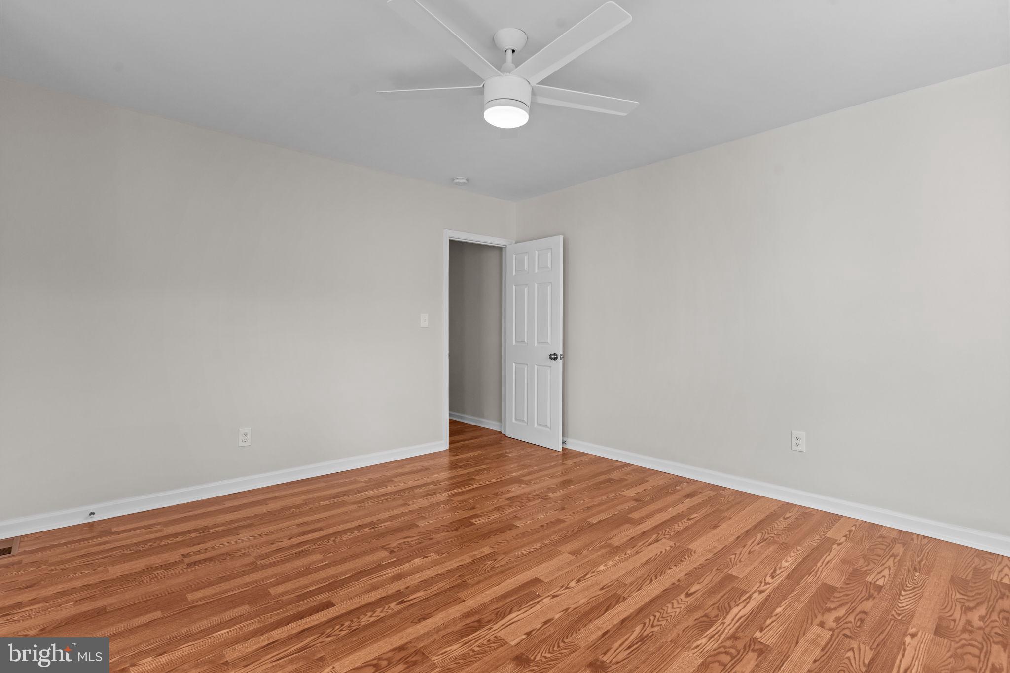 2142 North 58th Street Philadelphia, PA 19131 - Photo 22 of 36 an empty room with wooden floor and fan