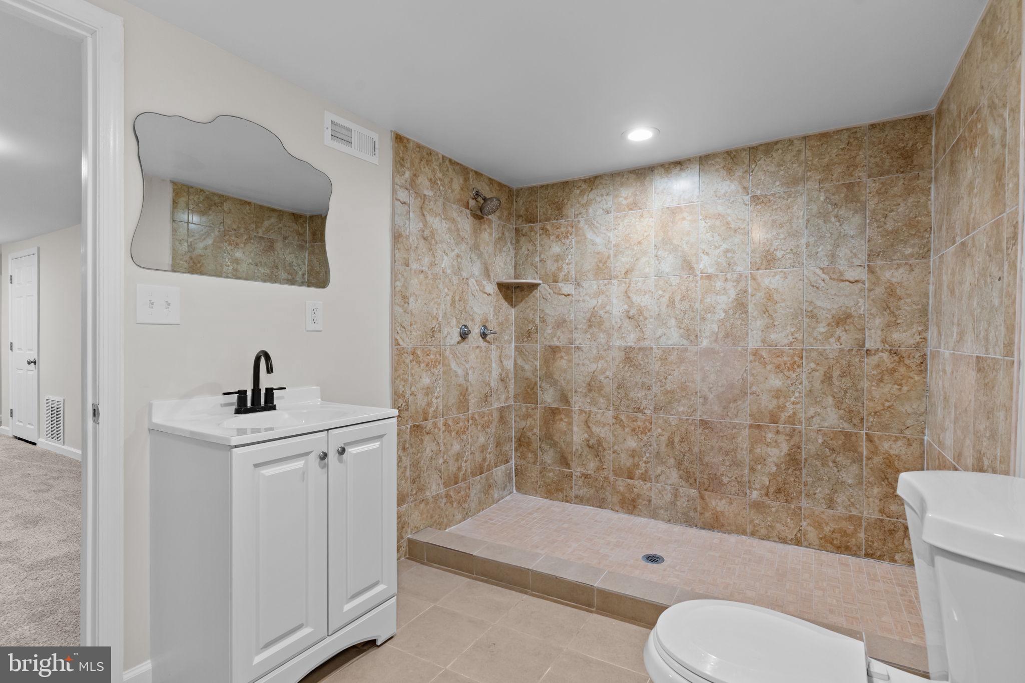 2142 North 58th Street Philadelphia, PA 19131 - Photo 28 of 36 a bathroom with a sink a toilet and shower