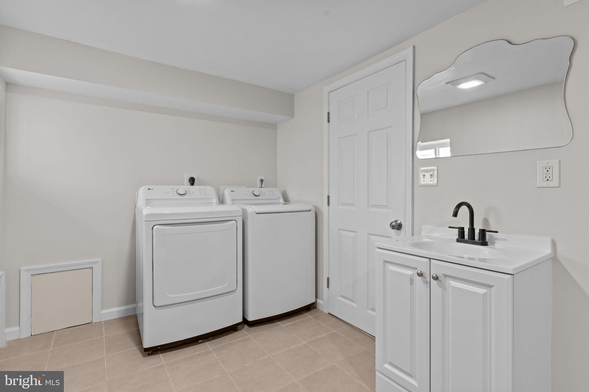 2142 North 58th Street Philadelphia, PA 19131 - Photo 29 of 36 a utility room with multiple dryer and washer