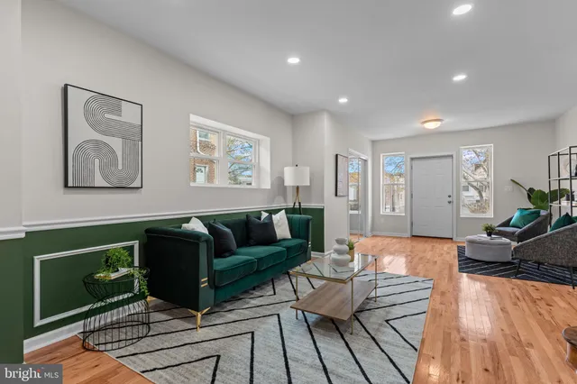 a living room with furniture and wooden floor
