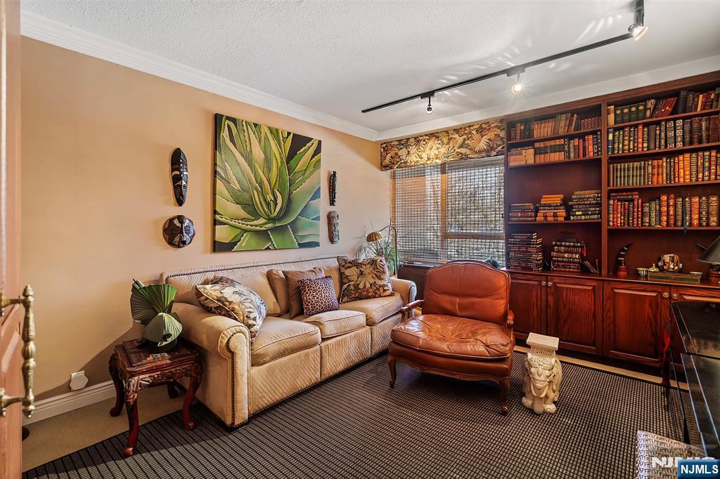 4 Horizon Road, Unit G10 Fort Lee, NJ 07024 - Photo 18 of 20 a living room with furniture a rug and a bookshelf