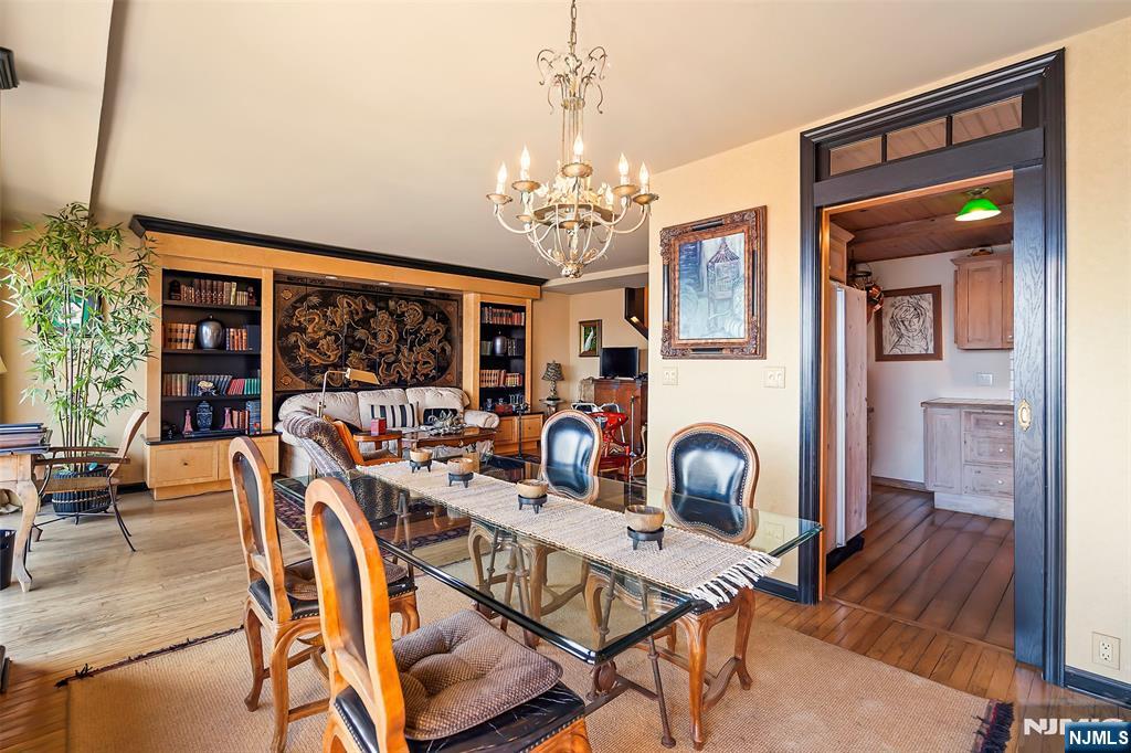 4 Horizon Road, Unit G10 Fort Lee, NJ 07024 - Photo 4 of 20 a view of a dining room with furniture and a chandelier