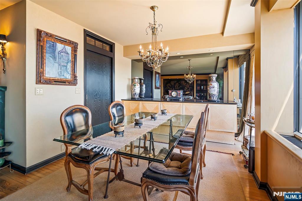 4 Horizon Road, Unit G10 Fort Lee, NJ 07024 - Photo 5 of 20 a view of a dining room with furniture and chandelier