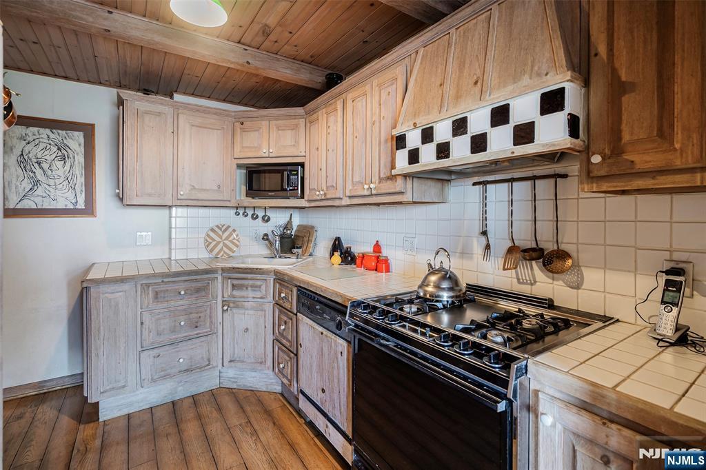 4 Horizon Road, Unit G10 Fort Lee, NJ 07024 - Photo 6 of 20 a kitchen with stainless steel appliances a stove a sink and a microwave
