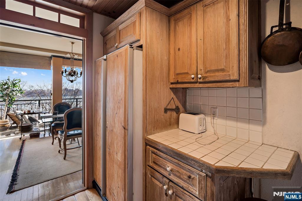 4 Horizon Road, Unit G10 Fort Lee, NJ 07024 - Photo 8 of 20 a kitchen with a refrigerator and table chair