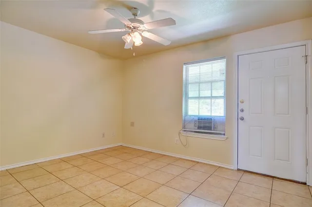 an empty room with fan and fan