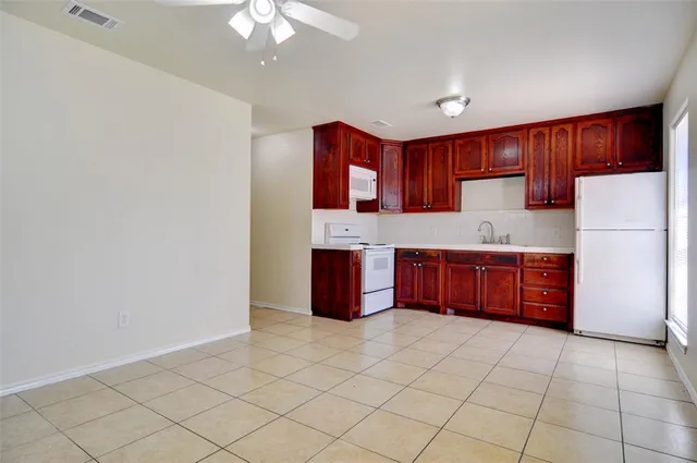 a kitchen with stainless steel appliances granite countertop a refrigerator stove a sink and dishwasher