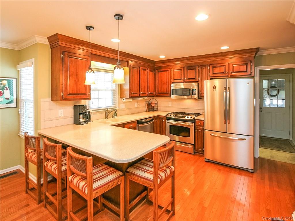2819 Farmstead Lane Fort Mill, SC 29708 - Photo 12 of 24 a kitchen with stainless steel appliances granite countertop a refrigerator a sink dishwasher and a stove with wooden floor