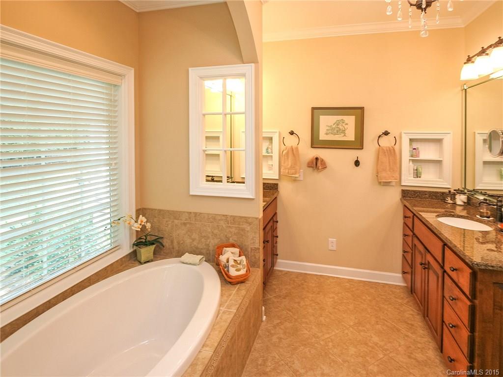 2819 Farmstead Lane Fort Mill, SC 29708 - Photo 17 of 24 a bathroom with a tub sink and mirror