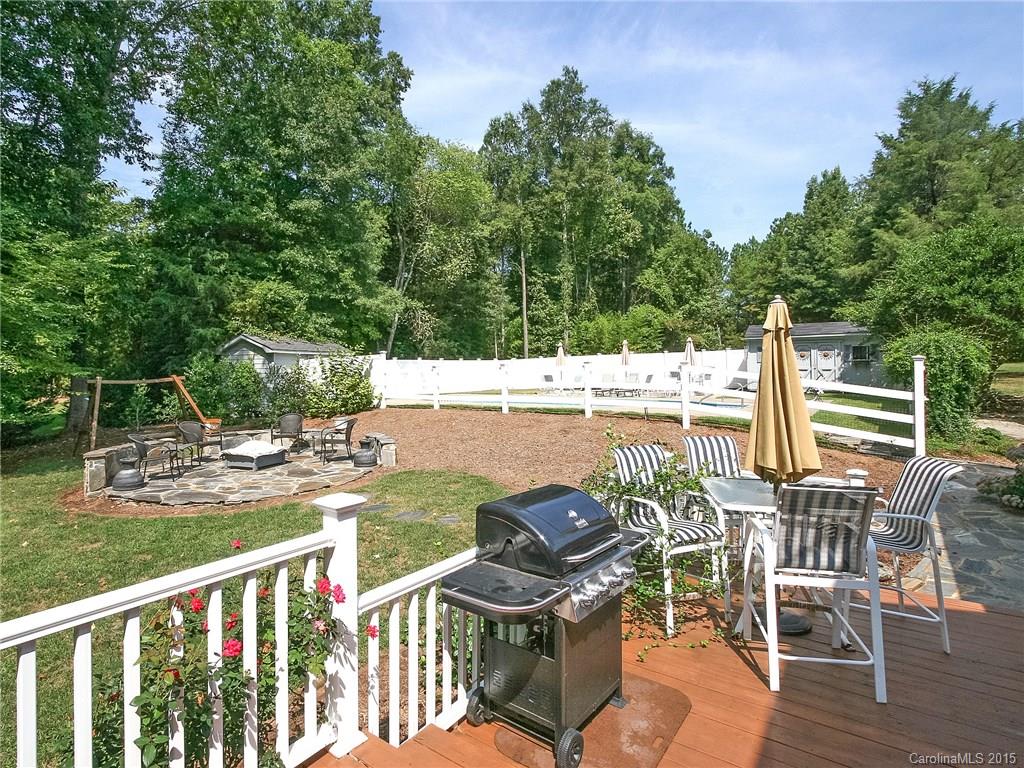 2819 Farmstead Lane Fort Mill, SC 29708 - Photo 4 of 24 a view of a chair and table on the wooden deck