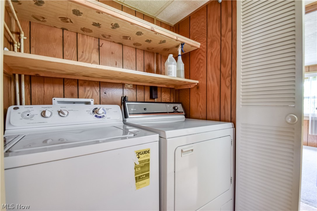 112 Lakeside Way Southwest Warren, OH 44481 - Photo 13 of 16 Dedicated laundry area featuring wood-paneled walls and a built-in shelving system