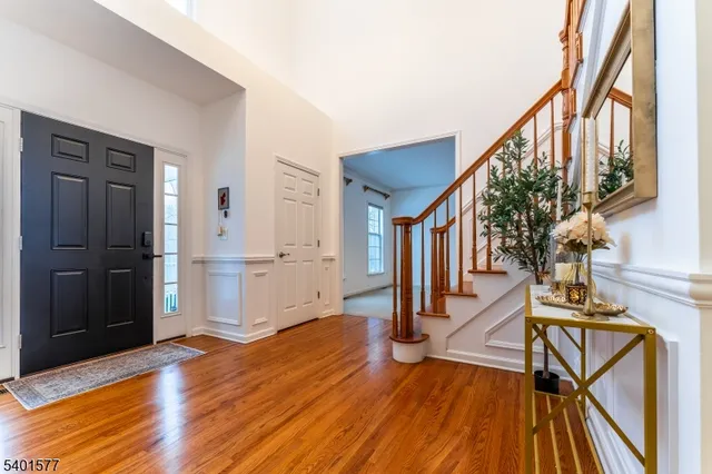 a view of an entryway with wooden floor and staircase