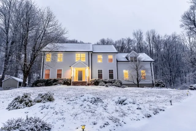 a view of a house with a yard covered in snow