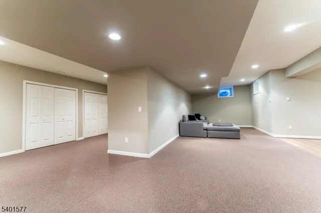 an empty room with windows and ceiling fan