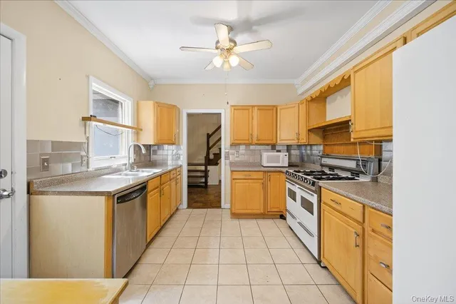 a kitchen with stainless steel appliances granite countertop a sink and a stove