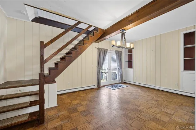 a view of an empty room with a fireplace and a window