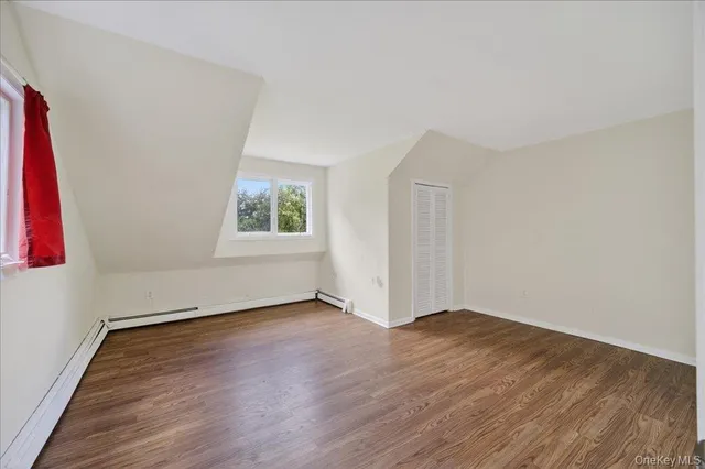 a view of a room with wooden floor