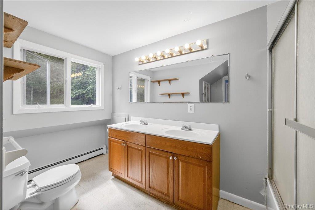 14 Moss Hill Road Holmes, NY 12531 - Photo 34 of 50 a bathroom with a sink a toilet a mirror and shower