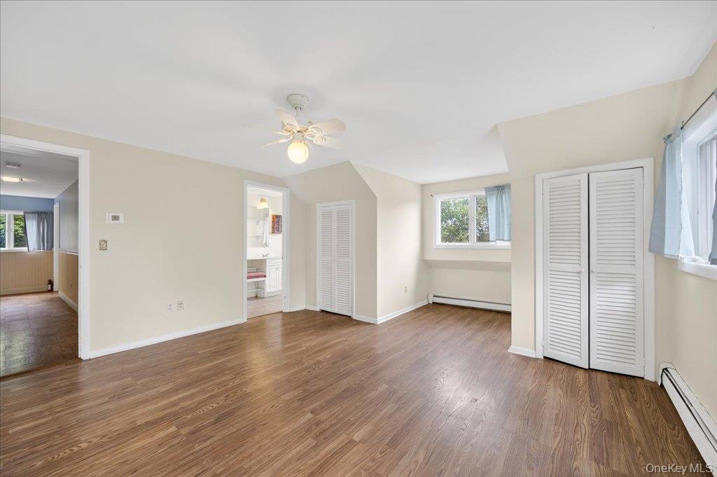 14 Moss Hill Road Holmes, NY 12531 - Photo 38 of 50 an empty room with wooden floor chandelier fan and windows