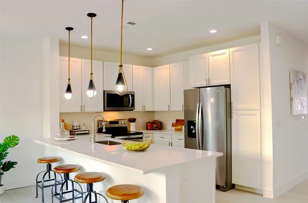 a kitchen with a sink a stove and cabinets