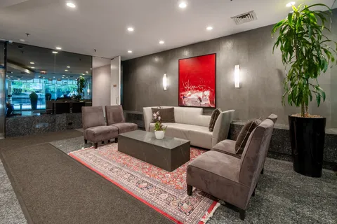 a living room with furniture a potted plant and a table