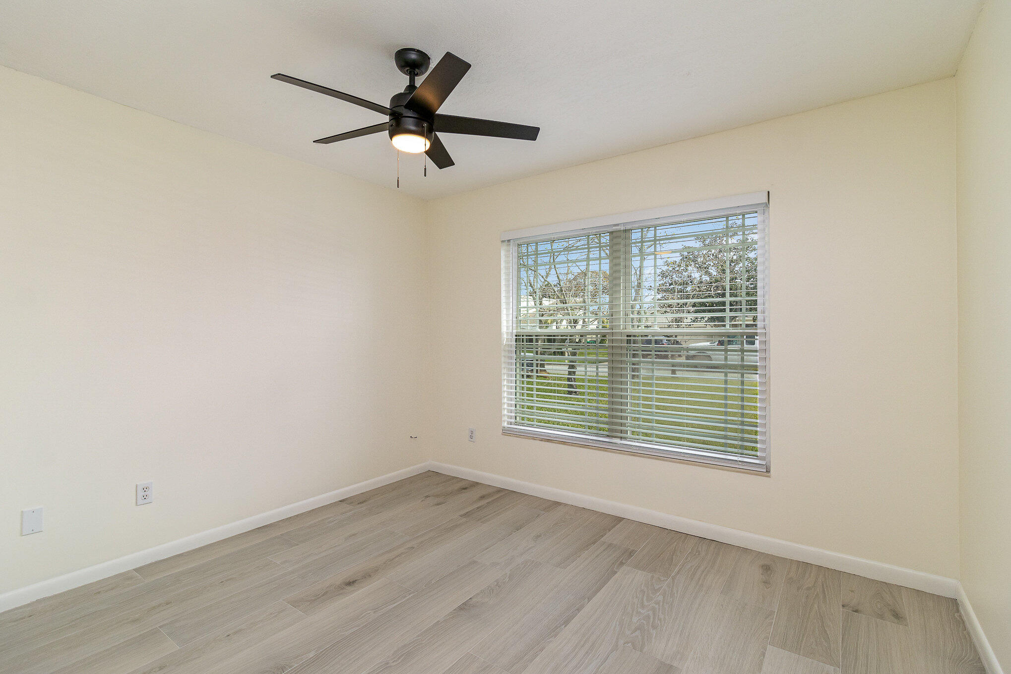 446 Timberlake Drive Melbourne, FL 32940 - Photo 14 of 20 a view of a room with wooden floor and a window